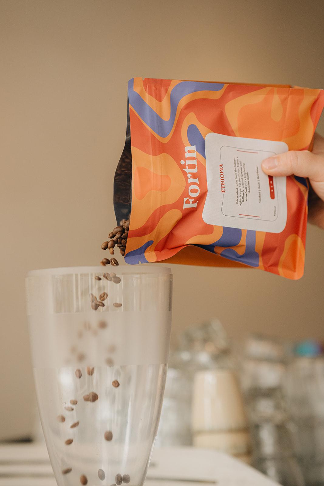 Fortin Ethiopia coffee beans being poured into a glass